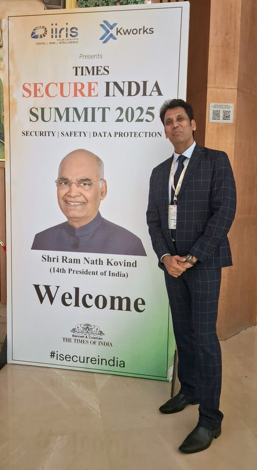 Capt. Prabhu beside the Times Secure India Summit 2025 welcome banner.